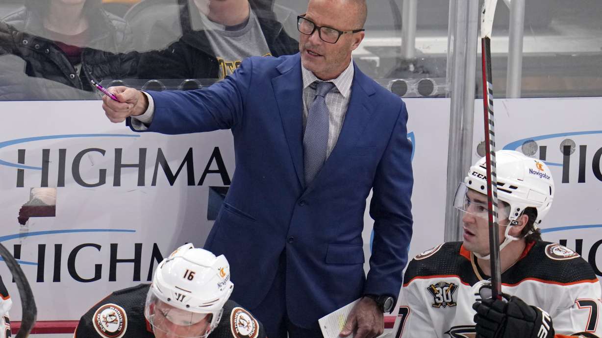 FILE - Anaheim Ducks head coach Greg Cronin stands behind his bench during the first period of an NHL hockey game against the Anaheim Ducks in Pittsburgh, Monday, Oct. 30, 2023.