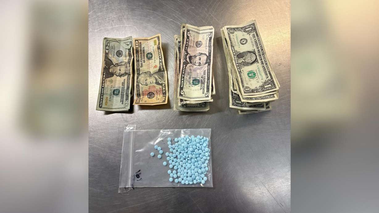 An undated photo of suspected fentanyl pills and cash seized during public safety enforcement on the Jordan River Trail in April.