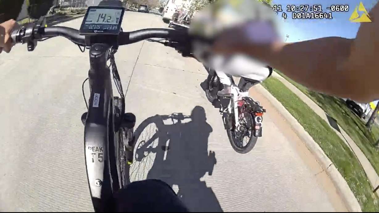 A screenshot from bodycamera footage on April 11, showing police chasing down a woman they say had felony warrants near the Jordan River Trail.