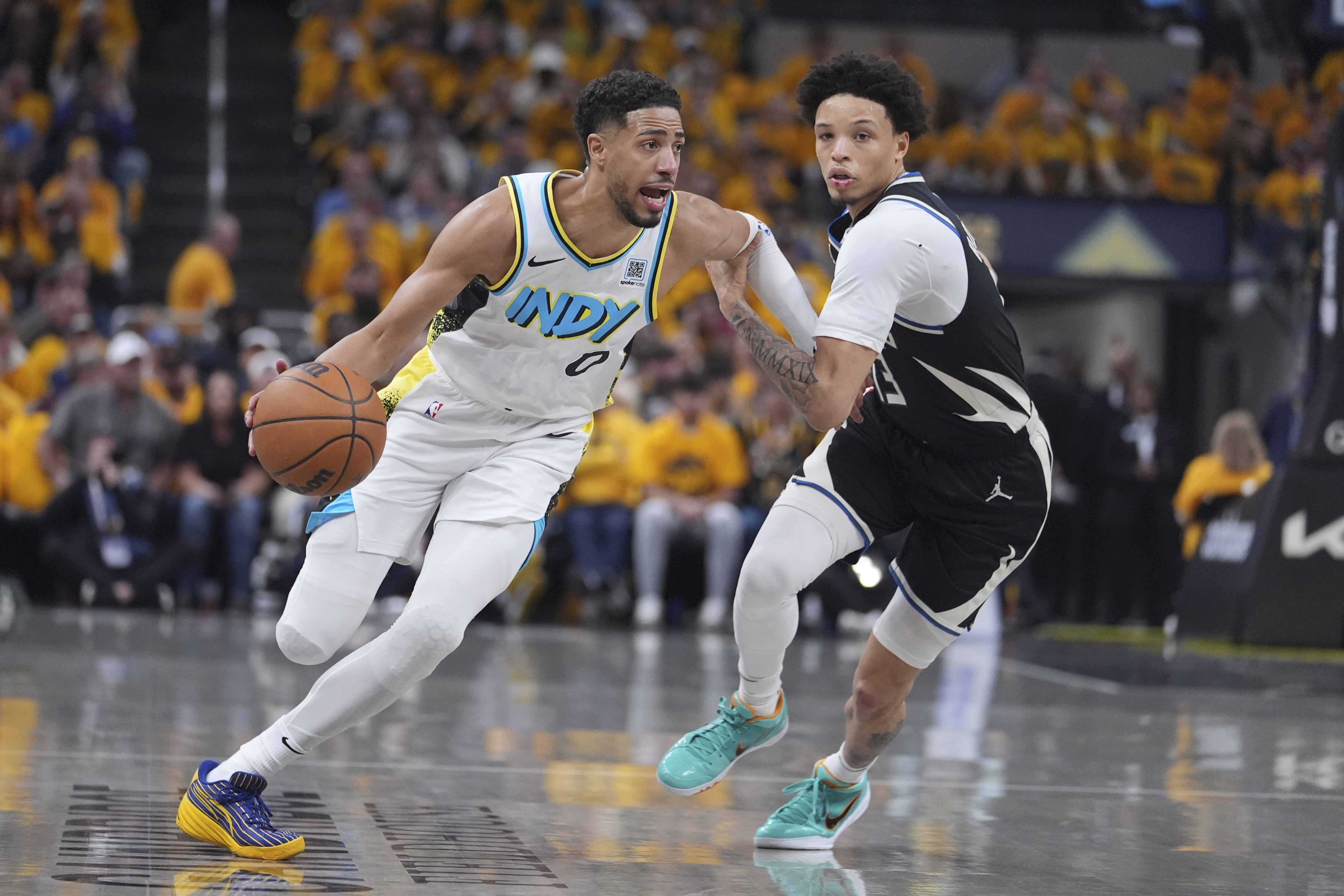Indiana Pacers' Tyrese Haliburton (0) drives past Milwaukee Bucks' Ryan Rollins during the first half of a first-round NBA basketball playoff game, Saturday, April 19, 2025, in Indianapolis.