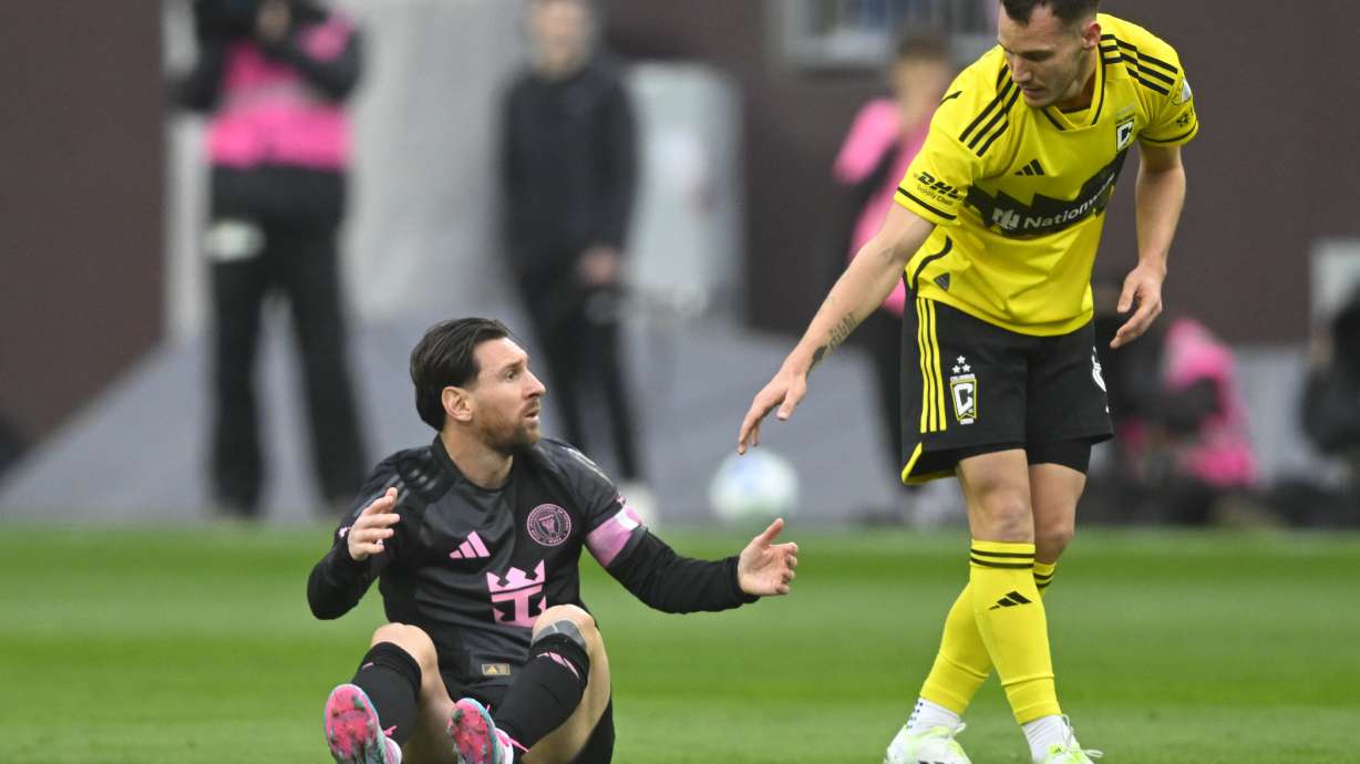 Columbus Crew midfielder Daniel Gazdag, right, reaches out to Inter Miami CF forward Lionel Messi during the first half of an MLS soccer match on Saturday, April 19, 2025, in Cleveland, Ohio.