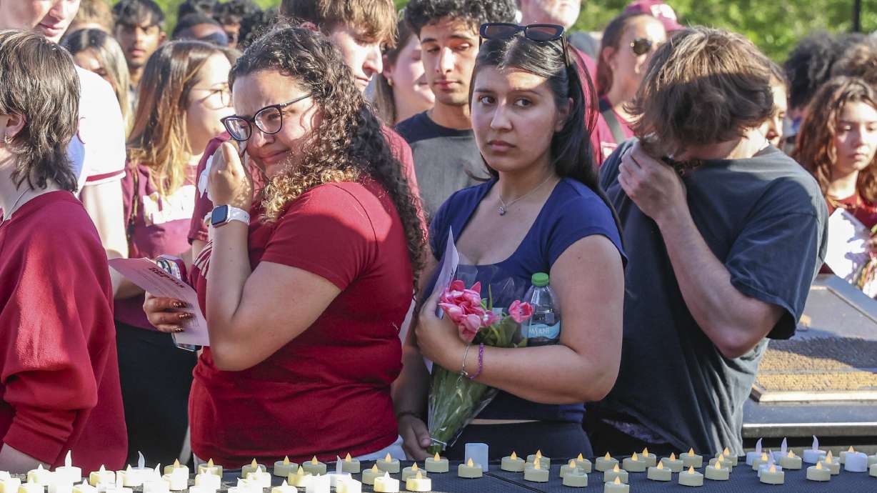 The day after an active shooter on campus Florida State students place electronic candles on a platform during a vigil on campus at Langford Green, Tallahassee, Fla., Friday. Classes will resume at FSU on Monday