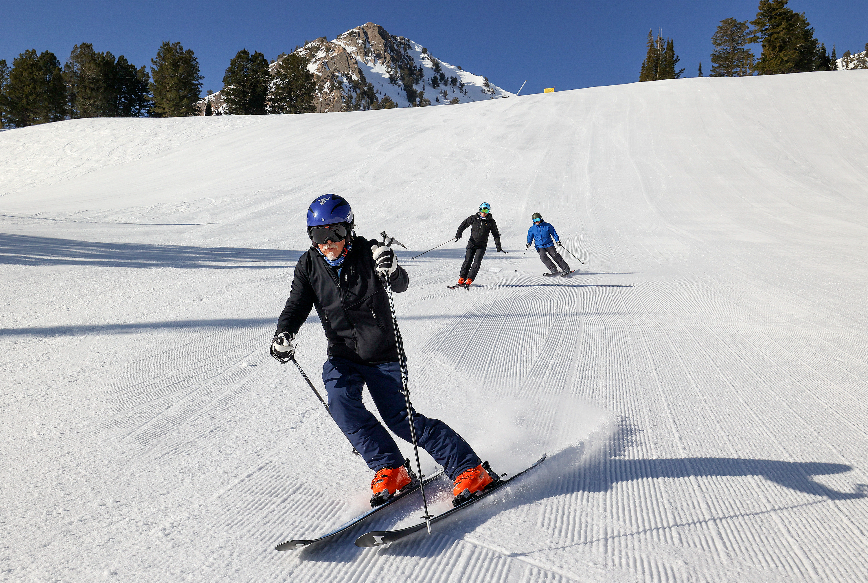 Tom Hart, known as Racer Tom, skies during a photo shoot at Snowbasin Resort in Weber County on April 10. Hart is trying to ski 10,000,000 vertical feet this season. His ski buddies Jeff Toone and Scott Harris are behind him.