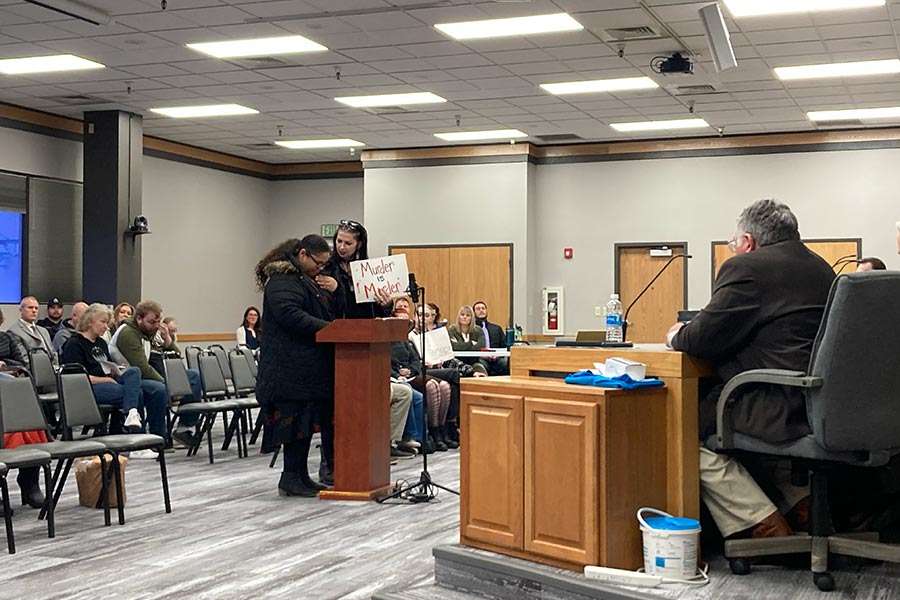 A woman comforts Erin Vossler as she gives her comment to the Pocatello City Council in Pocatello on Thursday.