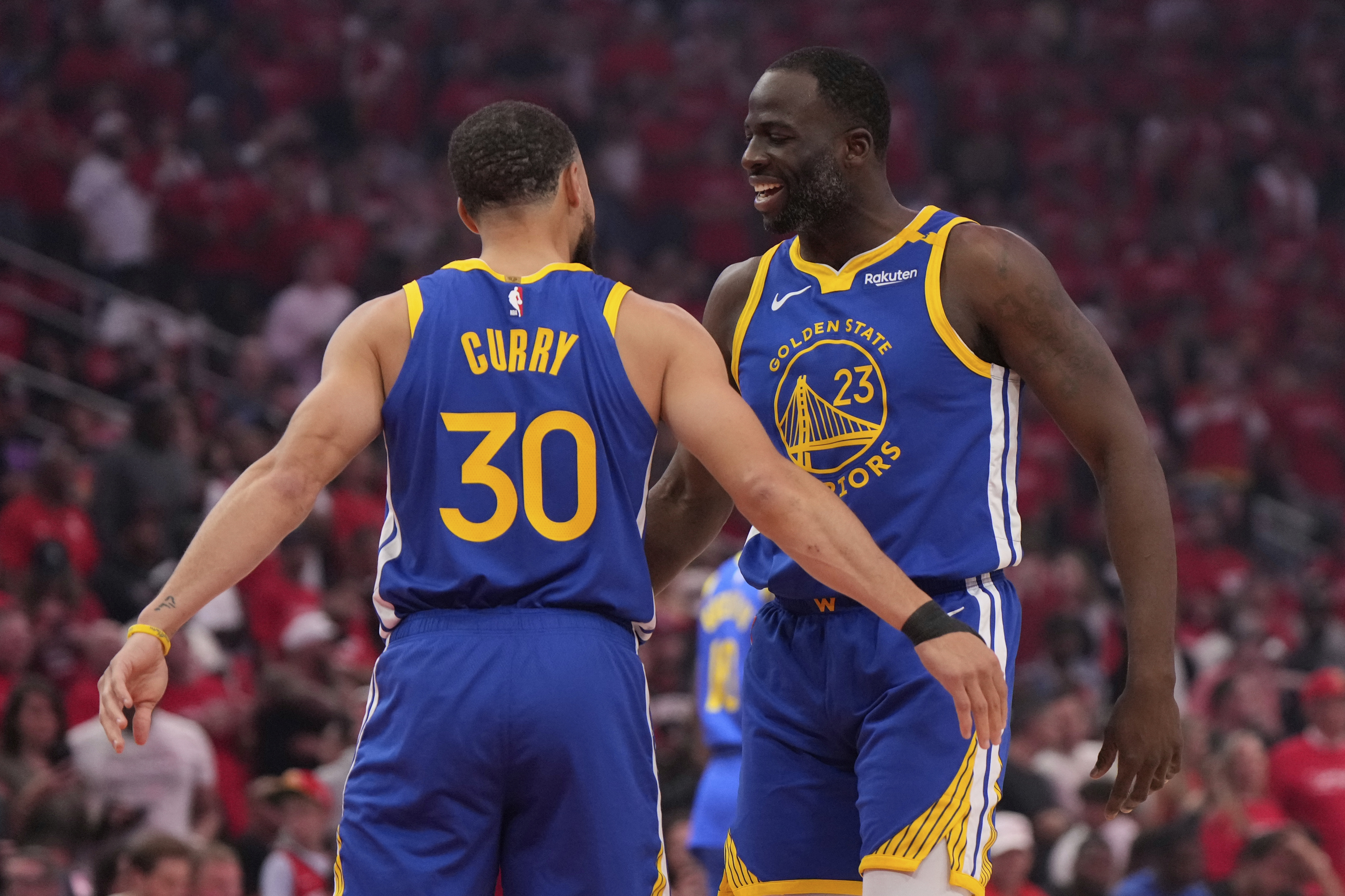 Golden State Warriors guard Stephen Curry (30) greets forward Draymond Green (23) before Game 1 of an NBA basketball first-round playoff series against the Houston Rockets in Houston, Sunday, April 20, 2025.
