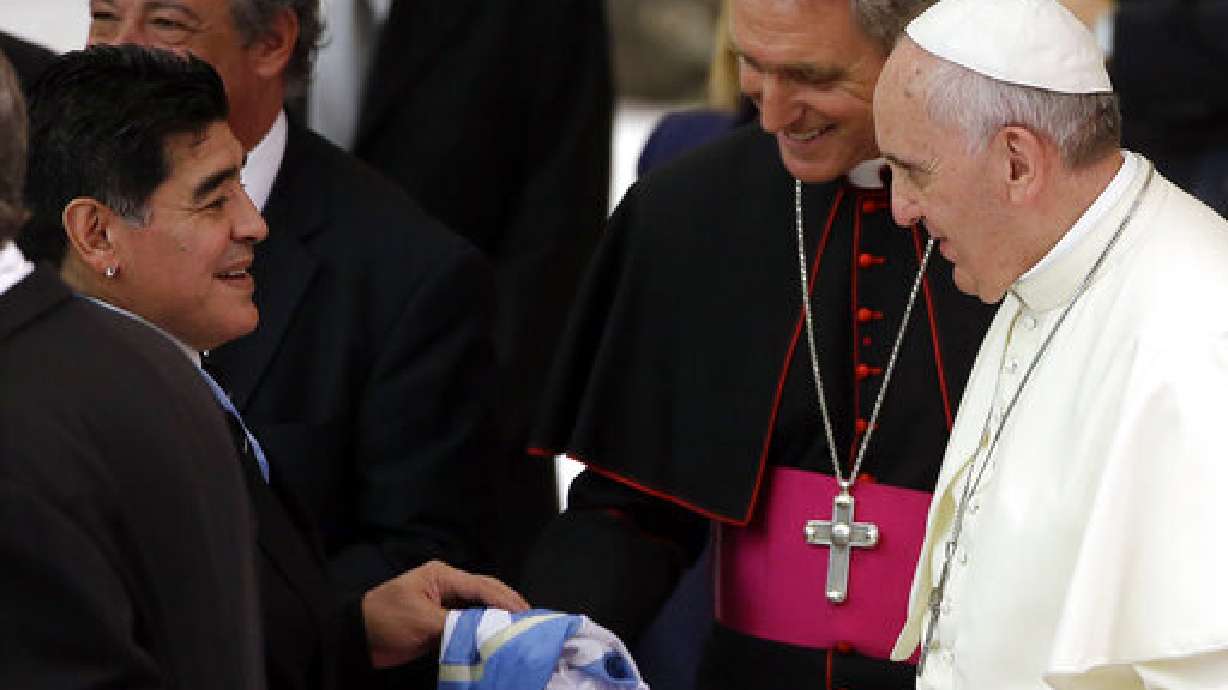 FILE - Argentine soccer legend Diego Armando Maradona, left, greets Pope Francis in the Paul VI hall at the Vatican, Monday, Sept. 1, 2014.