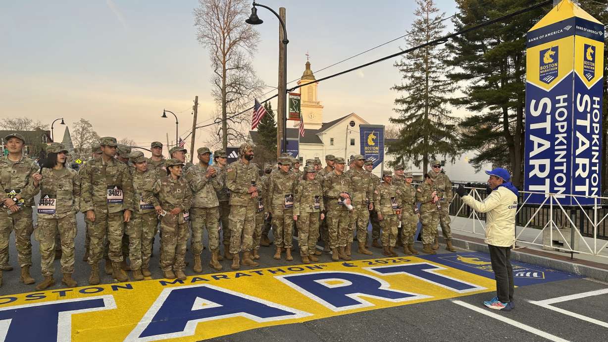 Boston Marathon Race Director Dave McGillivray, right, sends a group of Massachusetts National Guard members across the start line, launching the 129th edition of the race, in Hopkinton, Mass, early Monday, April 21, 2025.