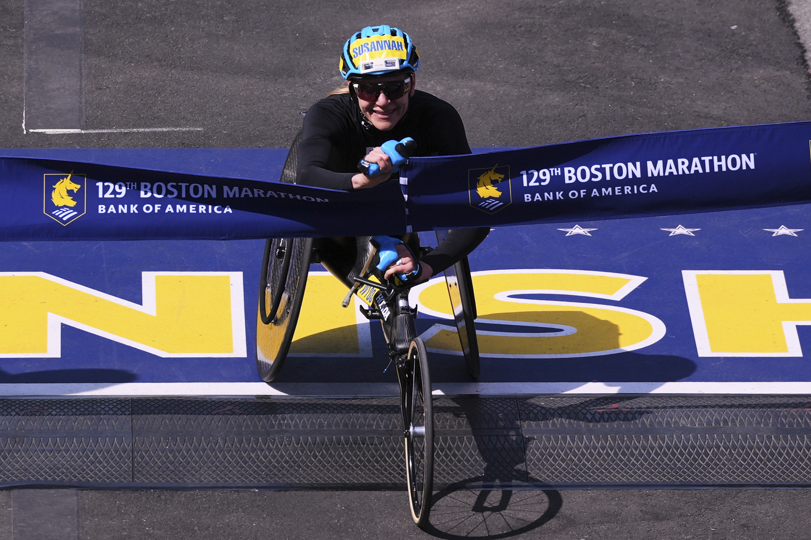 Susannah Scaroni, of the United States, breaks the tape to win the women's wheelchair division during the Boston Marathon, Monday, April 21, 2025, in Boston.