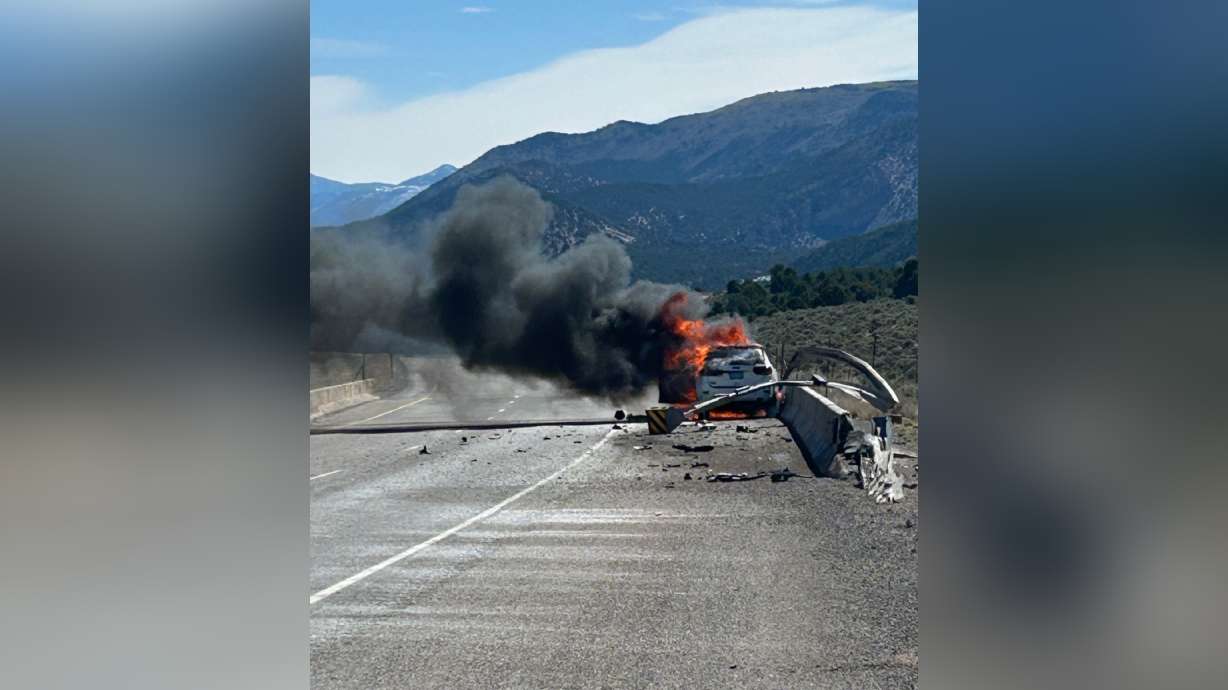 A car is seen in flames after a crash on I-70 in Sevier County on Monday.