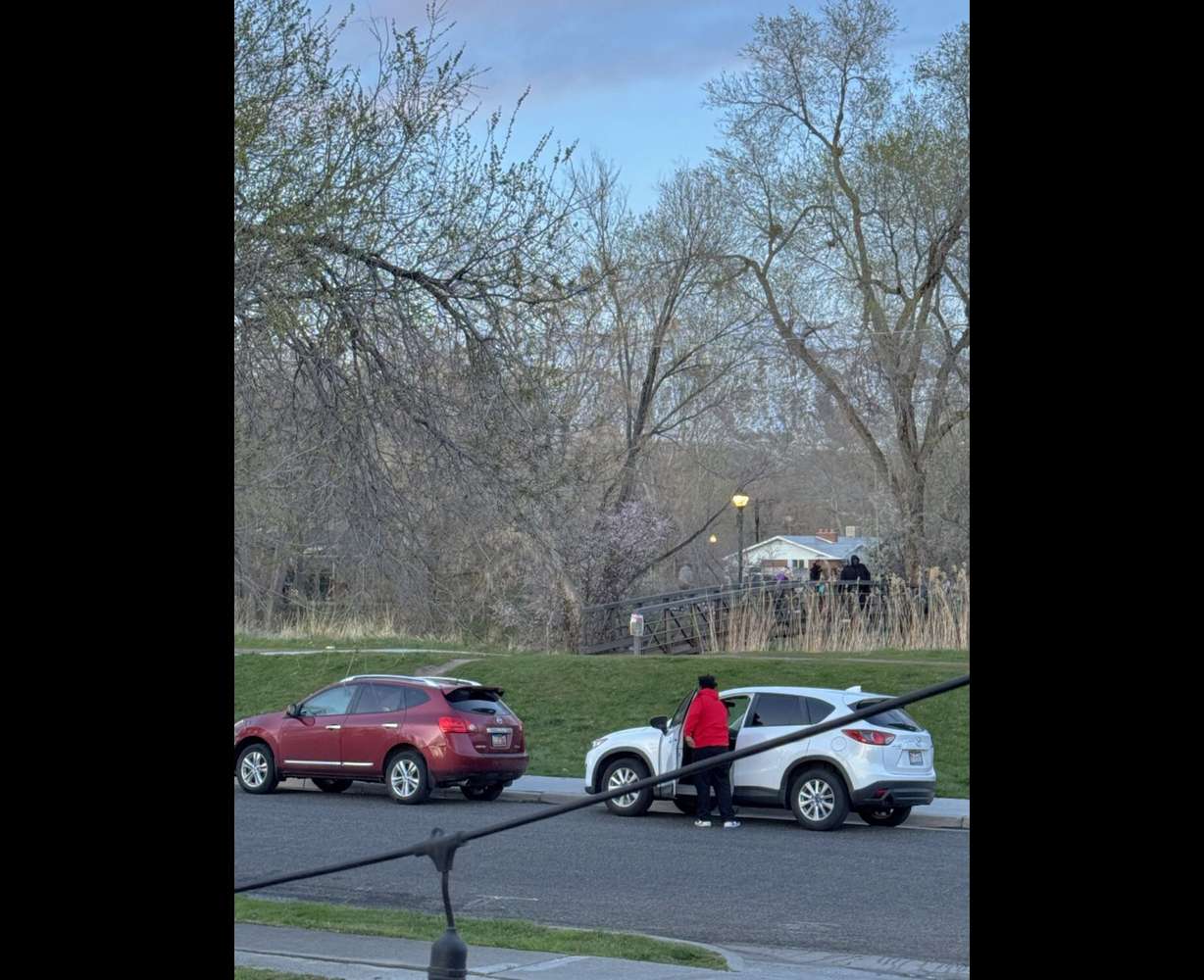 People gather at a bridge across the street from Aaron Sylvern’s residence along the Jordan River Trail in an undated photo.
