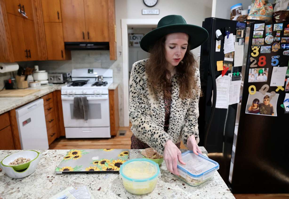 Ashlyne Hatch, who had her stomach removed a couple years ago, prepares a small meal at home in Mapleton on April 16. Hatch and her sister have the SMAD4 gene mutation, which leads to polyps in the digestive tract and eventually cancer. Without a stomach, Hatch can only handle very small meals, throughout the day.