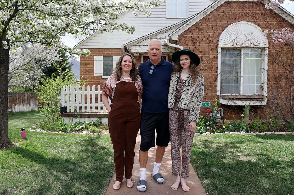 Chari Dickson, her father, Brent Hatch, and sister Ashlyne Hatch pose for a photo outside the Hatches' home in Mapleton on April 16. The sisters have the SMAD4 gene mutation, which leads to polyps in the digestive tract and eventually cancer.