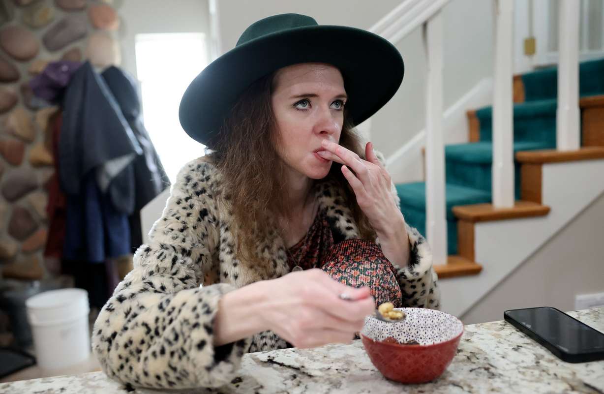 Ashlyne Hatch, who had her stomach removed a couple years ago, eats a small meal at home in Mapleton on April 16. She has the SMAD4 gene mutation, which leads to polyps in the digestive tract and eventually cancer.
