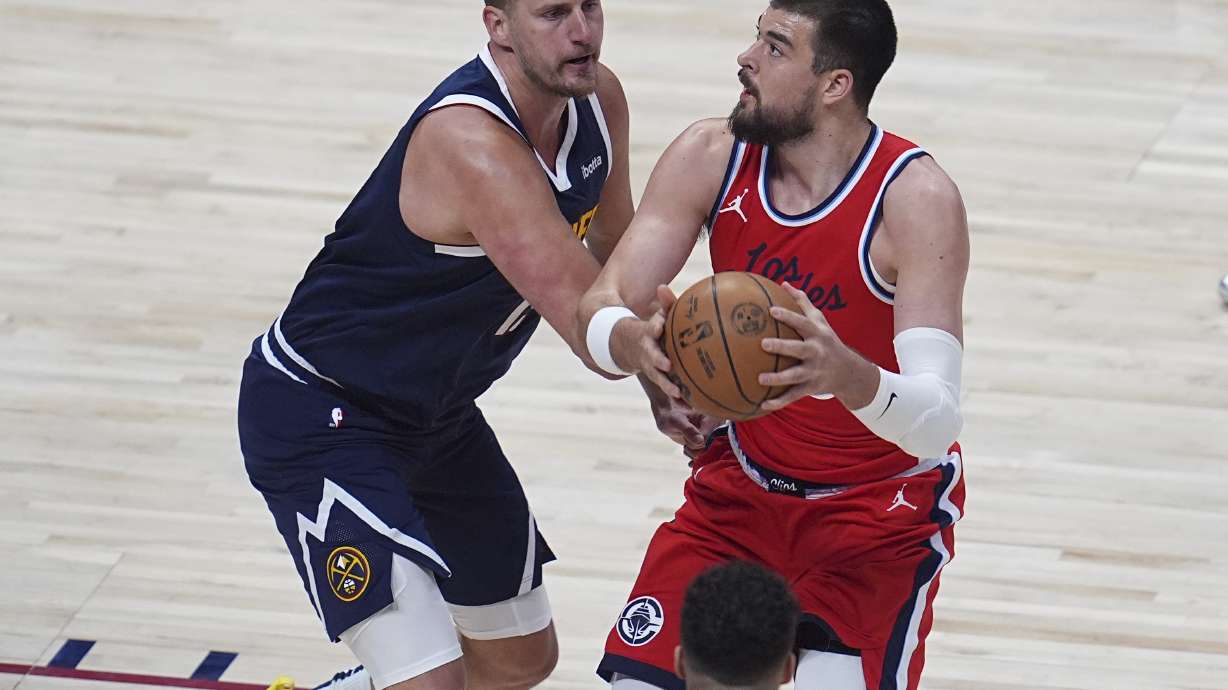 Los Angeles Clippers center Ivica Zubac, right, drives past Denver Nuggets center Nikola Jokic, left, in the first half of Game 2 of a first-round NBA playoff series Monday, April 21, 2025, in Denver.