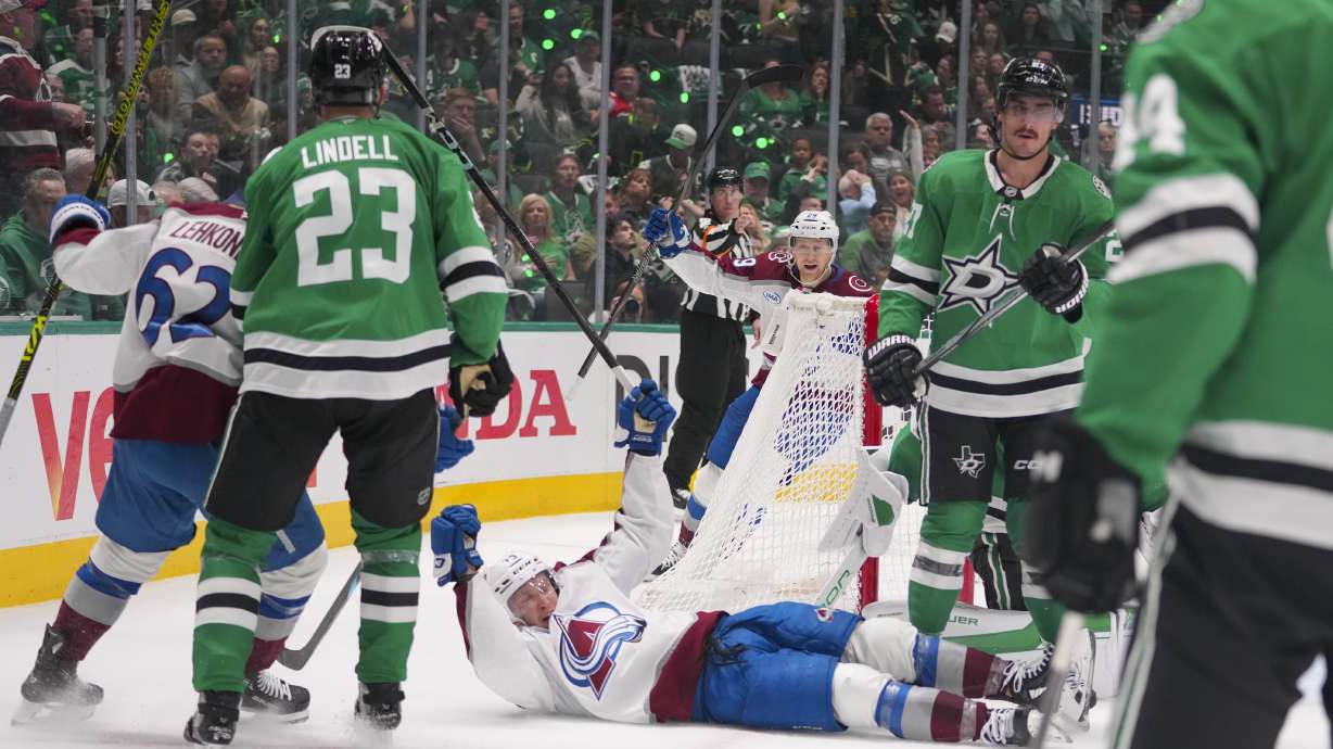 Colorado Avalanche right wing Logan O'Connor, bottom, reacts after scoring a goal against the Dallas Stars during the second period in Game 2 of a first-round NHL hockey playoff series Monday, April 21, 2025, in Dallas.