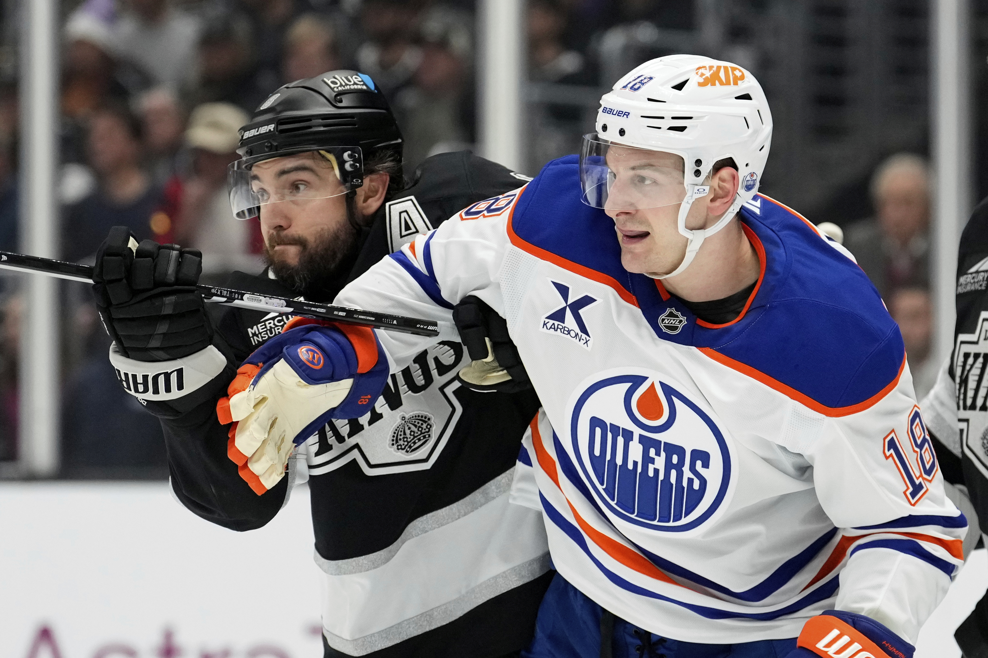 Los Angeles Kings defenseman Drew Doughty, left, and Edmonton Oilers left wing Zach Hyman scuffle in front of the goal during the first period in Game 1 of an NHL hockey first-round playoff series Monday, April 21, 2025, in Los Angeles.
