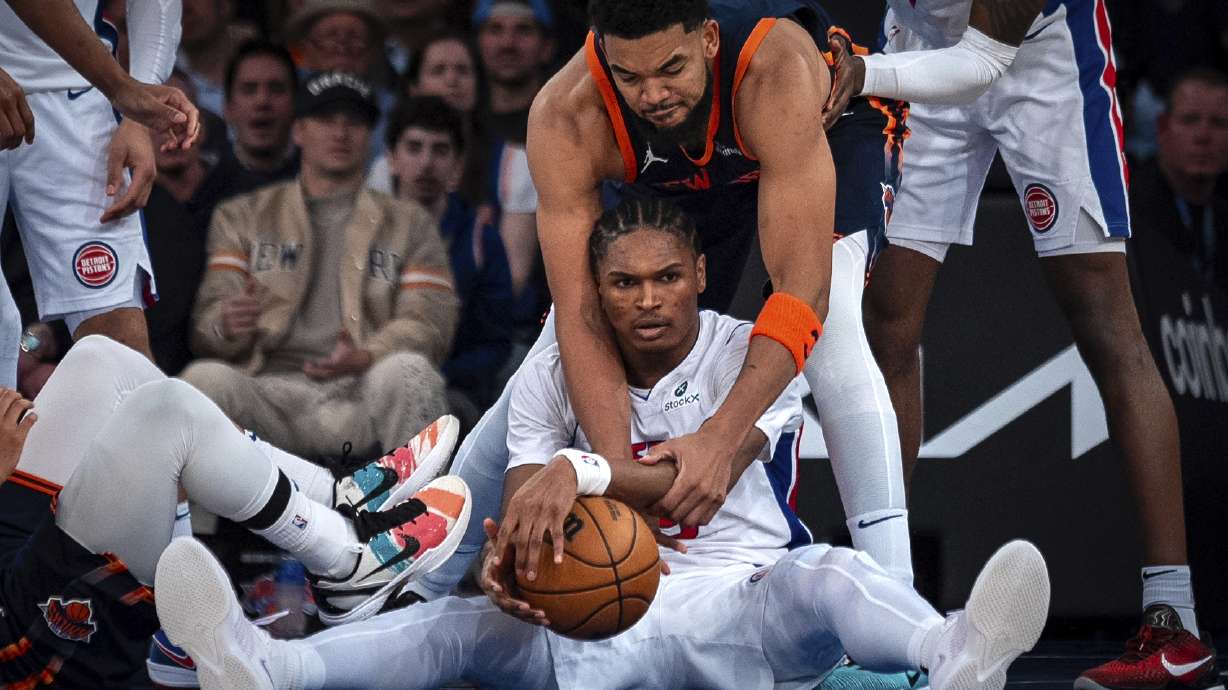 Detroit Pistons forward Ausar Thompson, center bottom, and New York Knicks center Karl-Anthony Towns, center top, fight for the ball during the second half of Game 2 of an NBA basketball first-round playoff series, Monday, April 21, 2025, in New York.