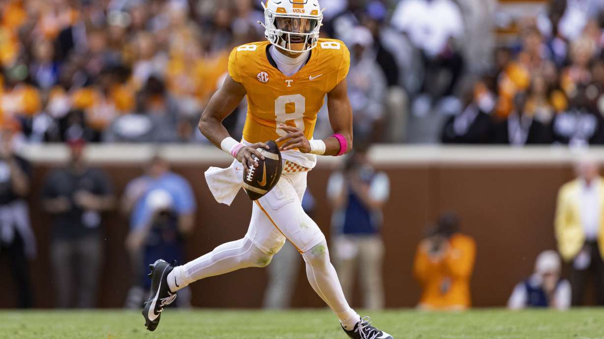 FILE - Tennessee quarterback Nico Iamaleava rolls out to pass during the first half of an NCAA college football game against Alabama, Saturday, Oct. 19, 2024, in Knoxville, Tenn.