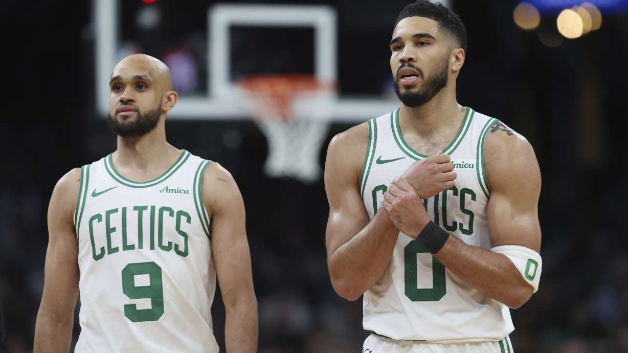 Boston Celtics' Jayson Tatum (0), right, reacts beside Derrick White after falling on a flagrant fowl by Orlando Magic's Kentavious Caldwell-Pope during the second half in Game 1 of a first-round NBA playoff basketball series Sunday, April 20, 2025, in Boston.