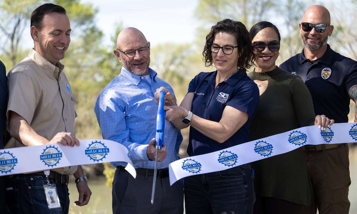 Millcreek Mayor Jeff Silvestrini and Salt Lake County Councilwoman Suzanne Harrison cut the ribbon as they officially open a new park, trail and boat launch along the Jordan River at 1015 West and 4000 South on Tuesday.