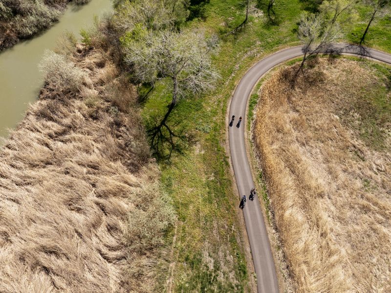 Cyclists ride e-bikes on the trail loop as Millcreek officially opens a new park, trail and boat launch along the Jordan River at 1015 West and 4000 South on Tuesday. - Scott G Winterton, Deseret News