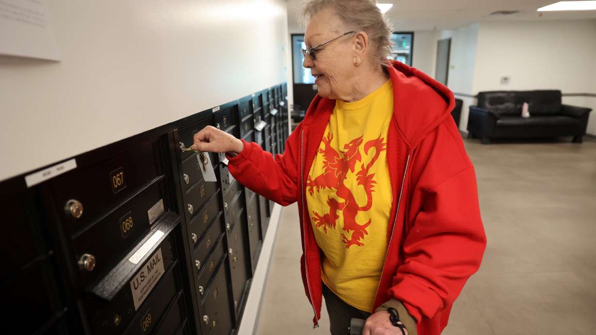 Win Hunnewell picks up her mail at New City Plaza, a deeply affordable senior housing development, in Salt Lake City on Tuesday. New City Plaza has 299 units for seniors, at least 62 years of age, with limited income.