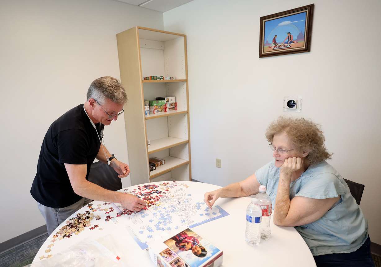 Jason Mayhew and his mother Carolyn Mayhew work on a puzzle in the puzzle room at New City Plaza, a deeply affordable senior housing development, in Salt Lake City on Tuesday, April 22, 2025. New City Plaza has 299 units for seniors at least 62 years of age, with limited income. Carolyn plans to move into New City Plaza Wednesday, after at least five years on the housing waitlist.