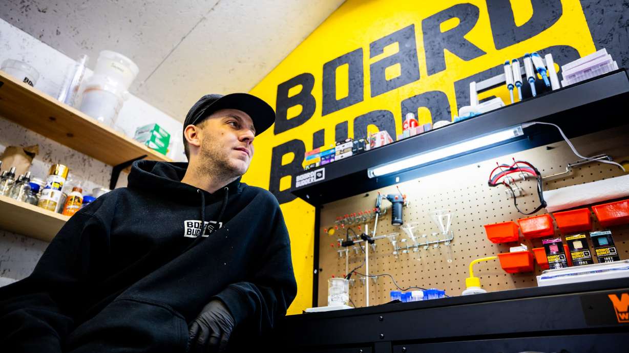 Erik Smith, a University of Utah Master of Business Creation student and founder and CEO of Board Budder, a ski and snowboard wax company, poses in his garage in Salt Lake City on Friday.