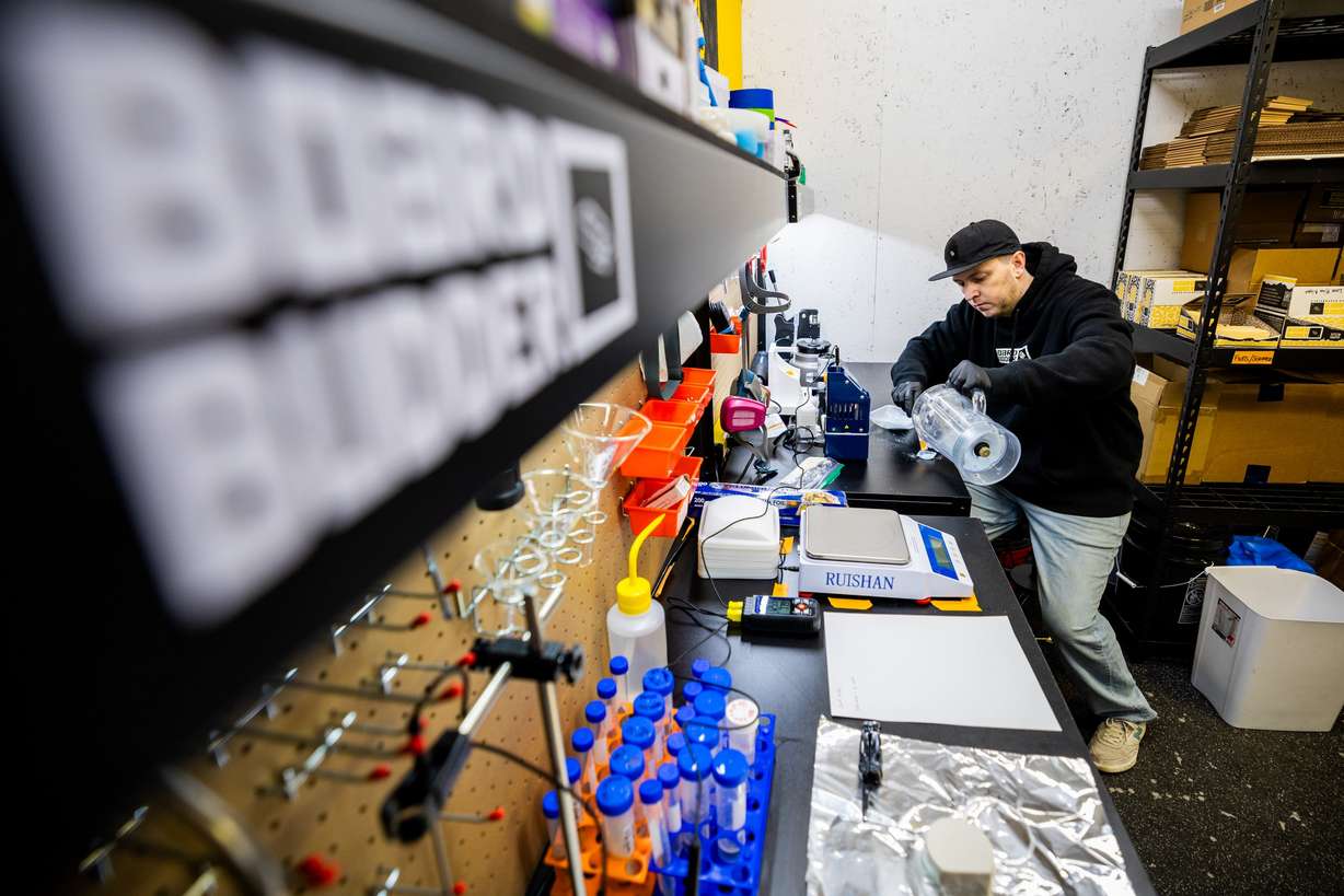 University of Utah Master of Business Creation student Erik Smith prepares powder to be loaded into a melting apparatus for his ski and snowboard wax company, Board Budder, inside his garage in Salt Lake City on Friday, April 18.