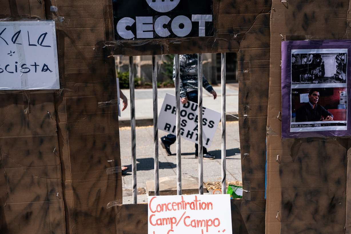 A protester walks past a mock prison during a demonstration against President Donald Trump's use of El Salvador's Terrorism Confinement Center prison for people deported from the United States outside the Salvadoran Embassy in Washington on April 14.