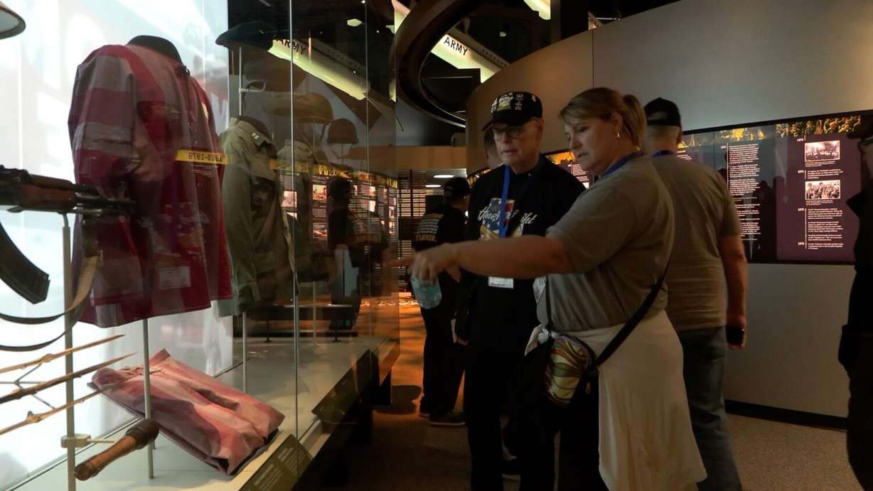 Jim Hayes looking over exhibits with a Utah Honor Flight volunteer.