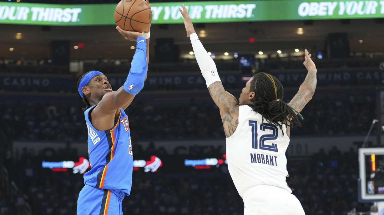 Oklahoma City Thunder guard Shai Gilgeous-Alexander, left, shoots over Memphis Grizzlies guard Ja Morant, right, during the first half in Game 1 of an NBA first-round playoff series, Tuesday, April 22, 2025, in Oklahoma City.