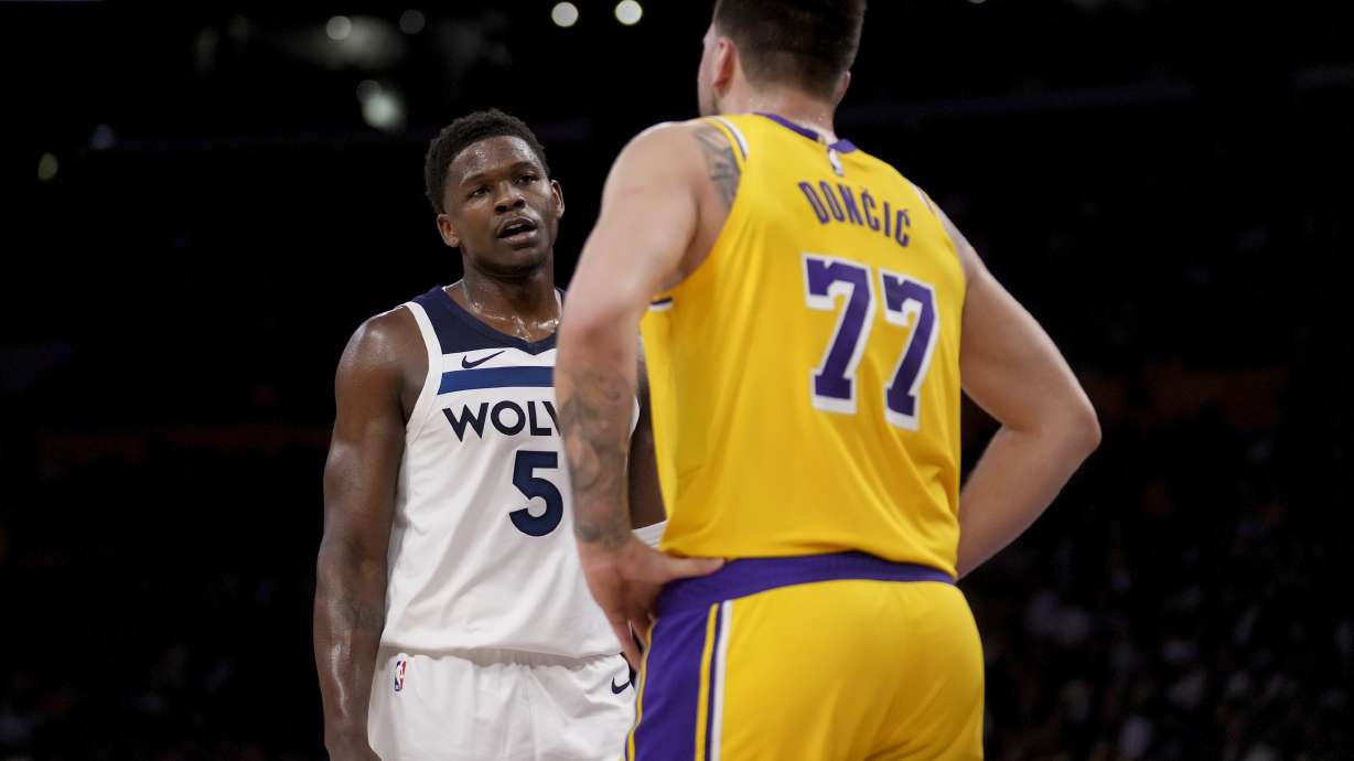 Minnesota Timberwolves guard Anthony Edwards (5) and Los Angeles Lakers guard Luka Doncic (77) interact during the first half of Game 2 of an NBA first-round playoff series in Los Angeles, Tuesday, April 22, 2025.