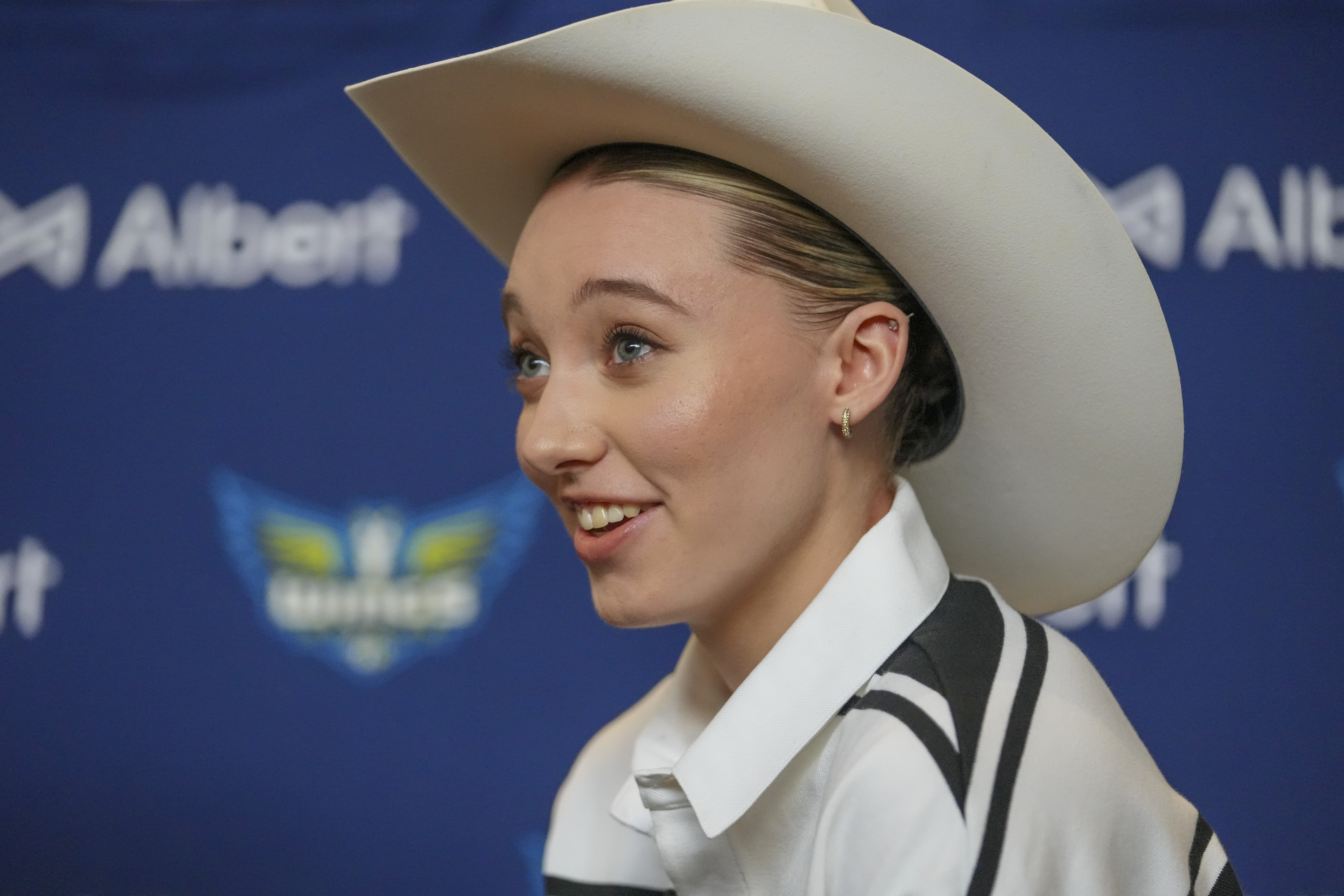 Dallas Wings' Paige Bueckers, selected No. 1 overall in the WNBA basketball draft, sports a cowboy hat gifted to her during an introductory press conference Wednesday, April 23, 2025, in Dallas.