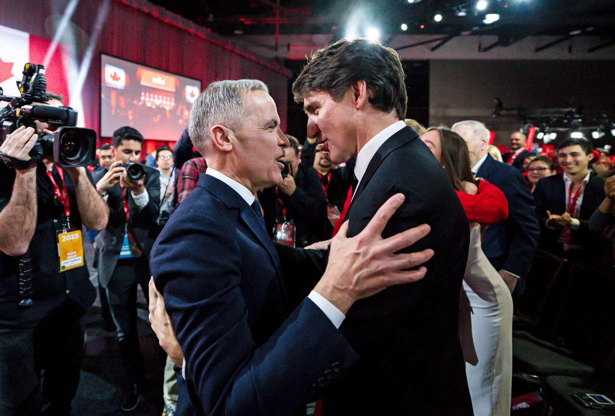 Mark Carney, leader of the Liberal Party of Canada, embraces Prime Minister Justin Trudeau after being announced the winner at the Liberal Leadership Event in Ottawa, Ontario, March 9.