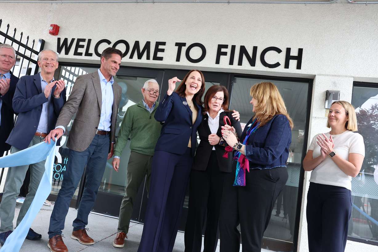Laurie Hopkins, executive director of Shelter the Homeless, hugs South Salt Lake Mayor Cherie Wood after the ribbon-cutting of the new Family Interim Non-Congregate Housing (FINCH) facility in South Salt Lake on Wednesday.