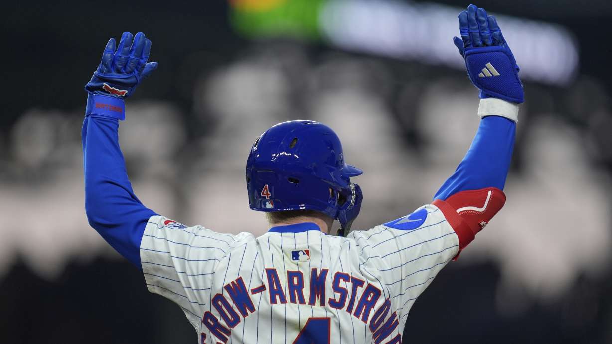 Chicago Cubs' Pete Crow-Armstrong (4) raises his arms after hitting a single during the fifth inning of a baseball game against the Los Angeles Dodgers, Wednesday, April 23, 2025, in Chicago.