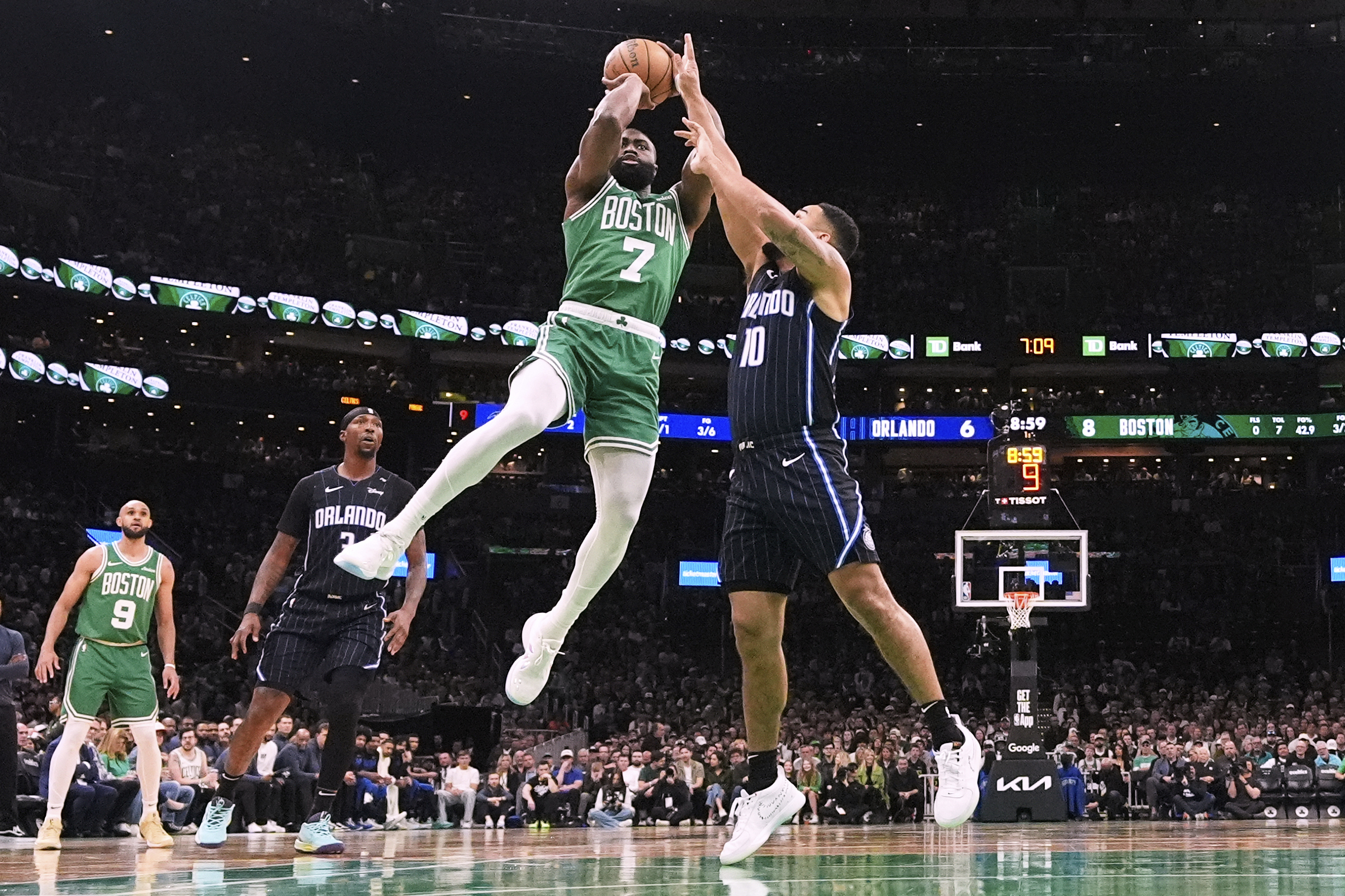 Boston Celtics guard Jaylen Brown (7) takes a shot while pressured by Orlando Magic guard Cory Joseph (10) during the first half in game 2 of a first-round NBA playoff basketball series, Wednesday, April 23, 2025, in Boston.