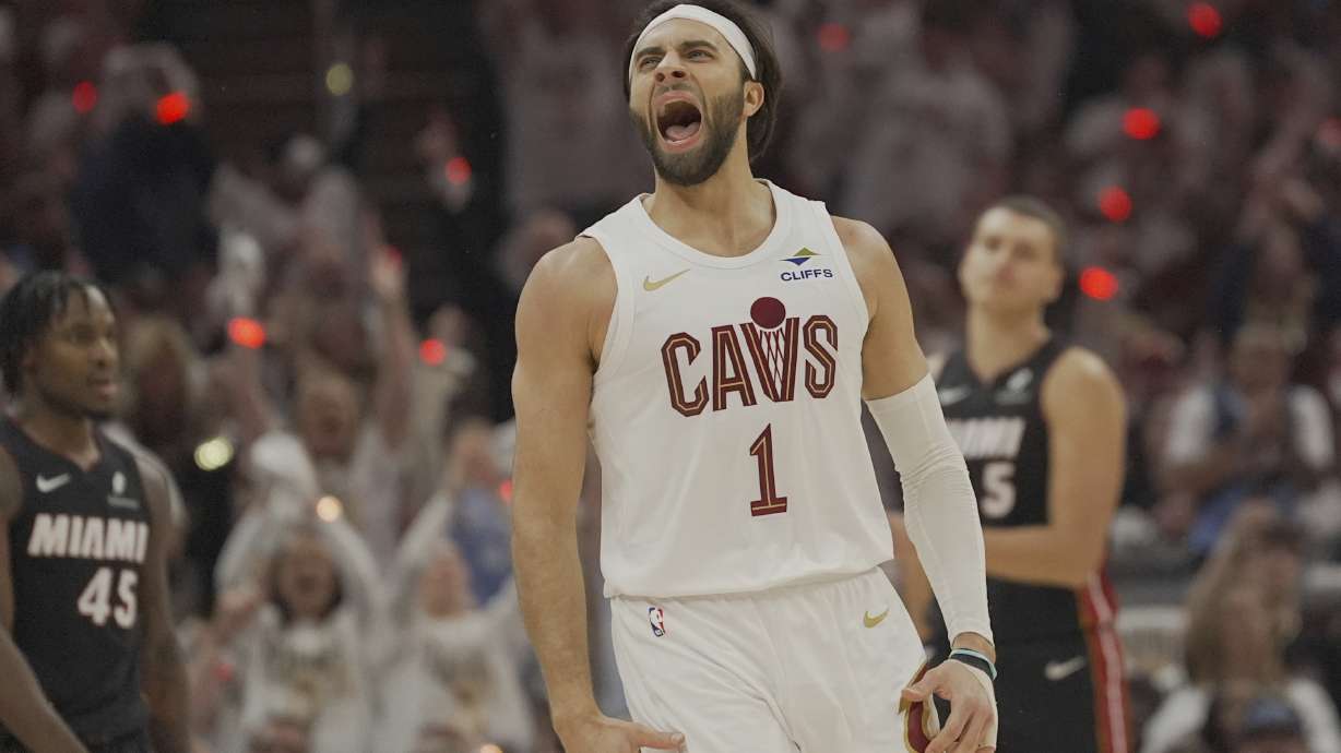 Cleveland Cavaliers guard Max Strus (1) shouts in front of Miami Heat guard Davion Mitchell (45) and forward Nikola Jovic (5) after hitting a three-point basket in the first half in Game 2 of an NBA first-round playoff series, Wednesday, April 23, 2025, in Cleveland.
