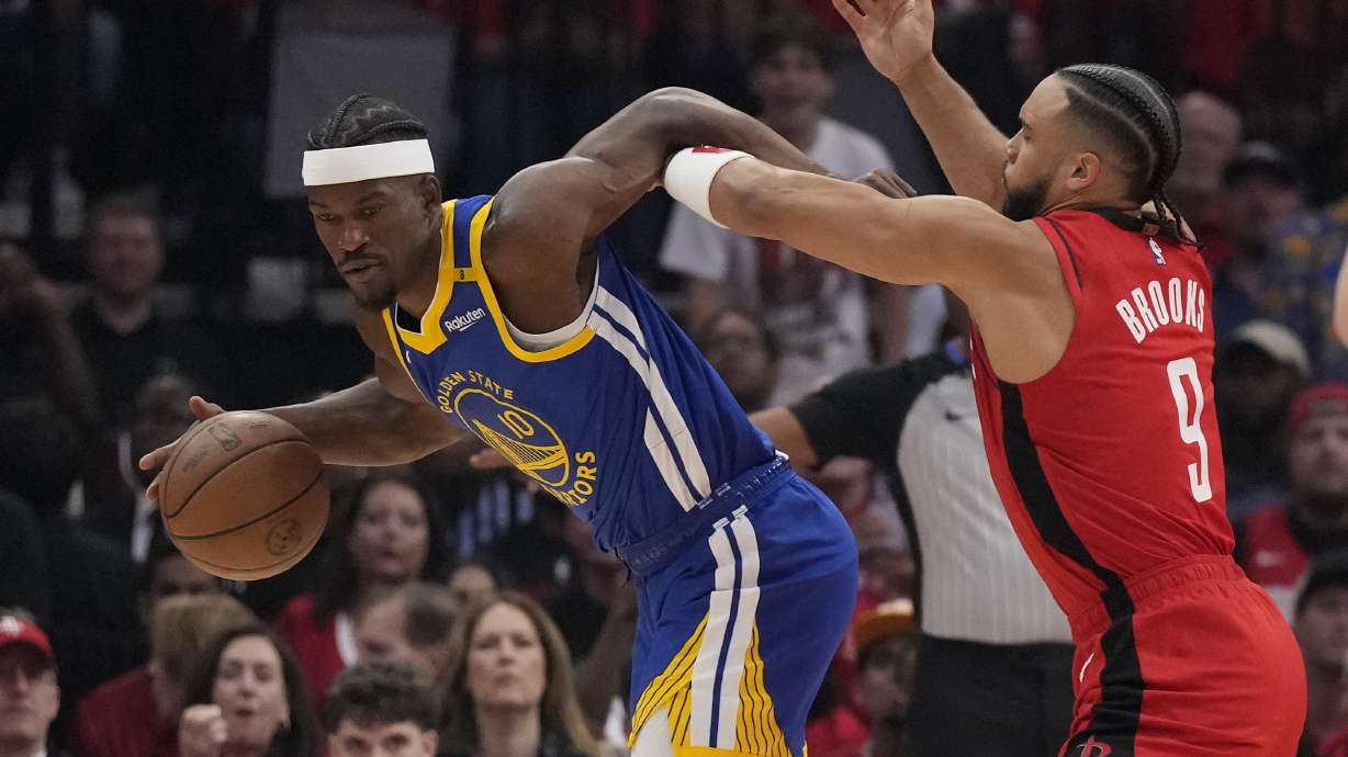 Houston Rockets forward Dillon Brooks (9) defends against Golden State Warriors forward Jimmy Butler III (10) during the first half of Game 2 of an NBA basketball first-round playoff series against the Houston Rockets in Houston, Wednesday, April 23, 2025.