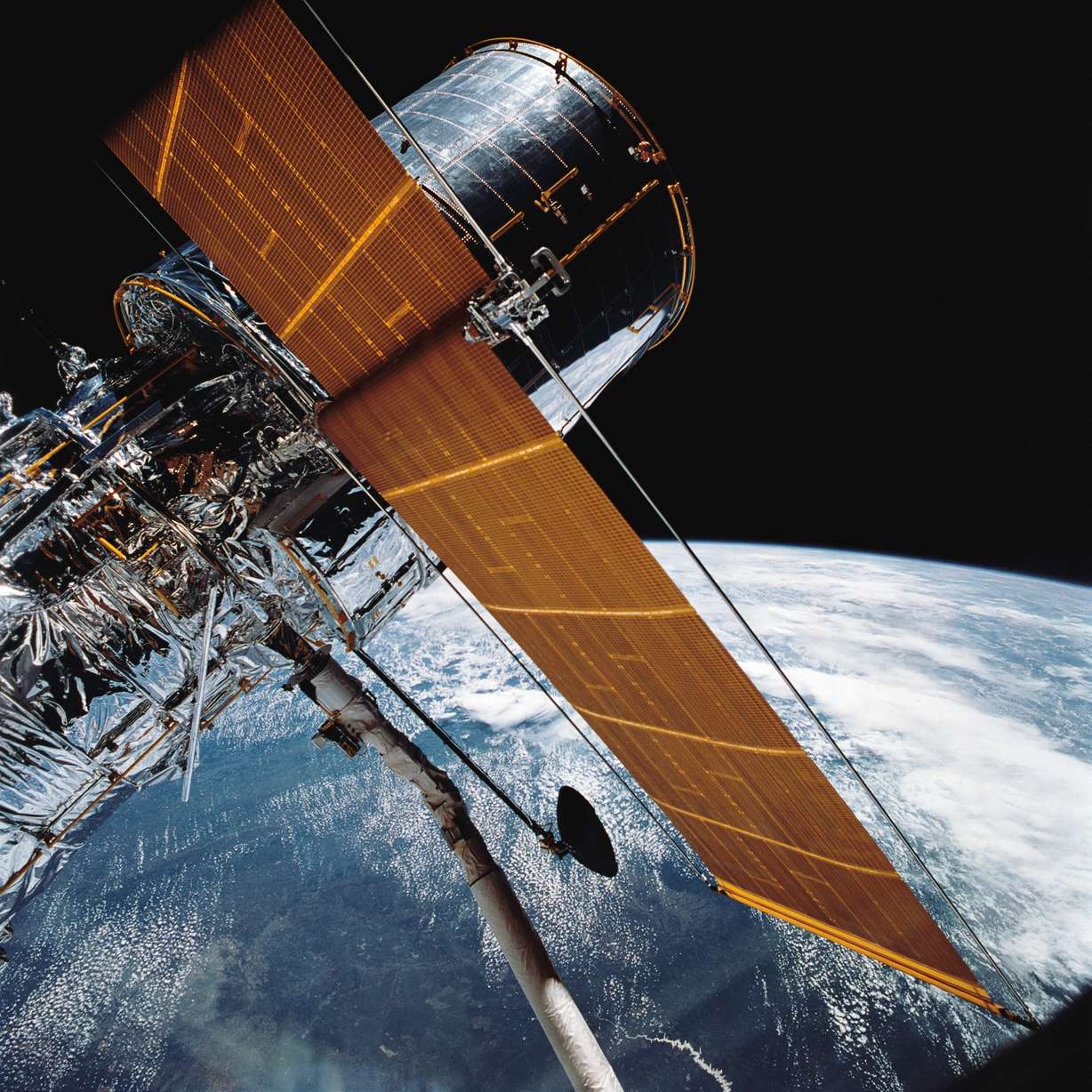 In this April 25, 1990, photograph provided by NASA, most of the giant Hubble Space Telescope can be seen as it is suspended in space by Discovery's Remote Manipulator System following the deployment of part of its solar panels and antennae. This was among the first photos NASA released on April 30 from the five-day STS-31 mission. The Hubble Space Telescope, one of NASA's crowning glories, is marking its 35th anniversary.
