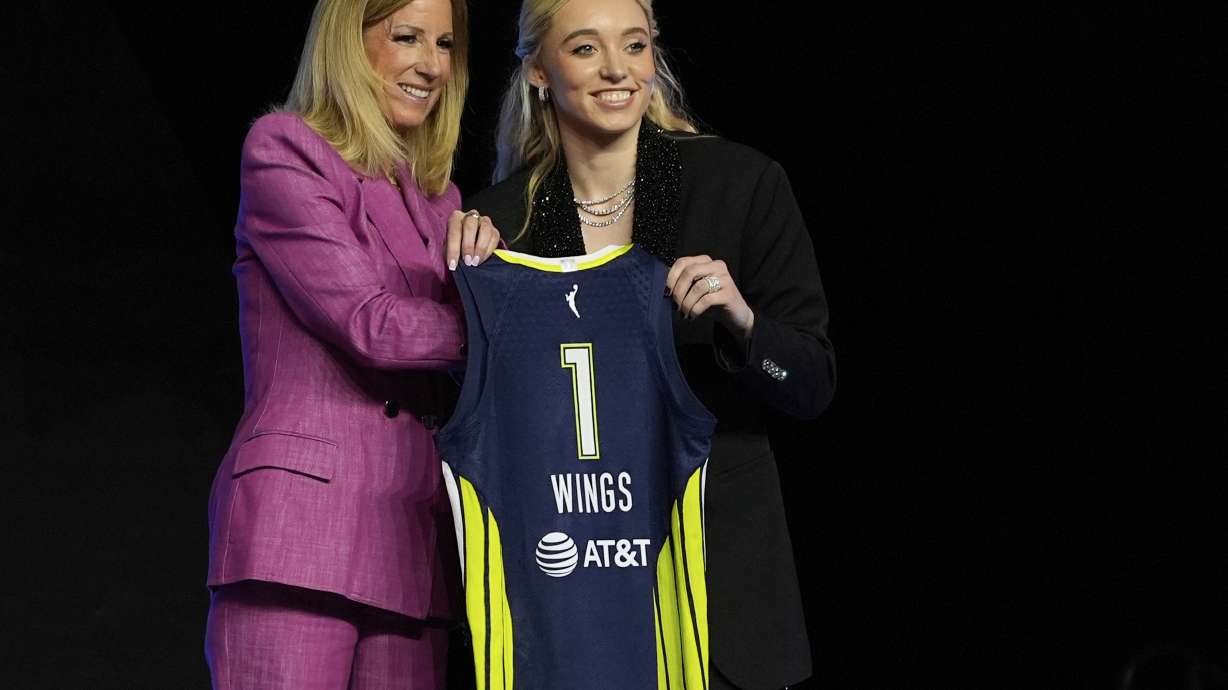 UConn's Paige Bueckers, right, poses for a photo with WNBA commissioner Cathy Engelbert after being selected first overall by the Dallas Wings during the first round of the WNBA basketball draft, Monday, April 14, 2025, in New York.