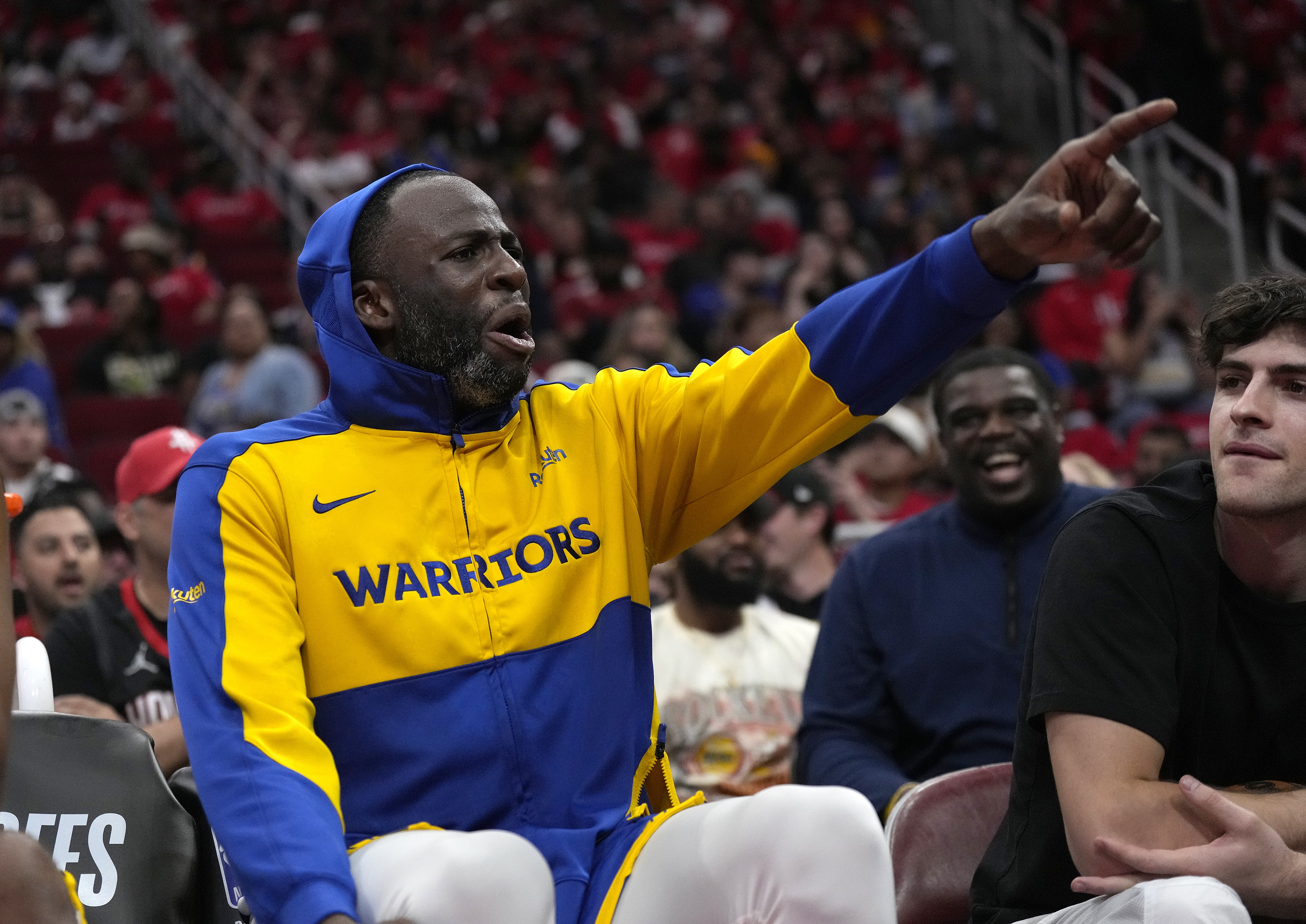 Golden State Warriors' Draymond Green yells at Houston Rockets fans from the bench after leaving the game during the second half of Game 2 of an NBA basketball first-round playoff series against the Houston Rockets in Houston, Wednesday, April 23, 2025.