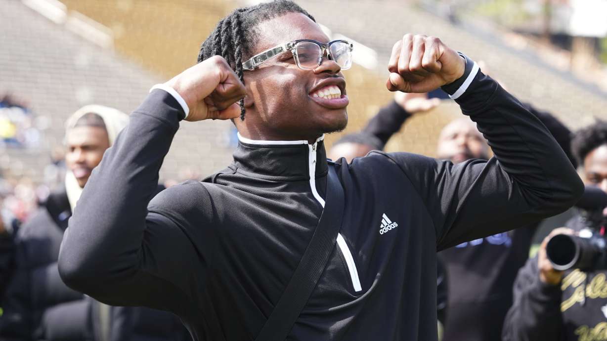 Travis Hunter reacts to his jersey retirement during Colorado's NCAA college football spring game, Saturday, April 19, 2025, in Boulder, Colo.