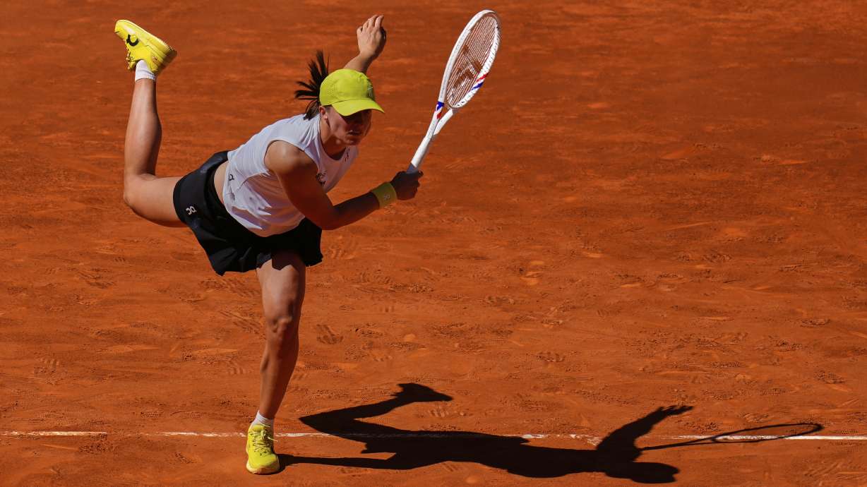 Poland's Iga Swiatek serves against Alexandra Eala of Philippines during the Madrid Open tennis tournament in Madrid, Spain, Thursday, April 24, 2025.