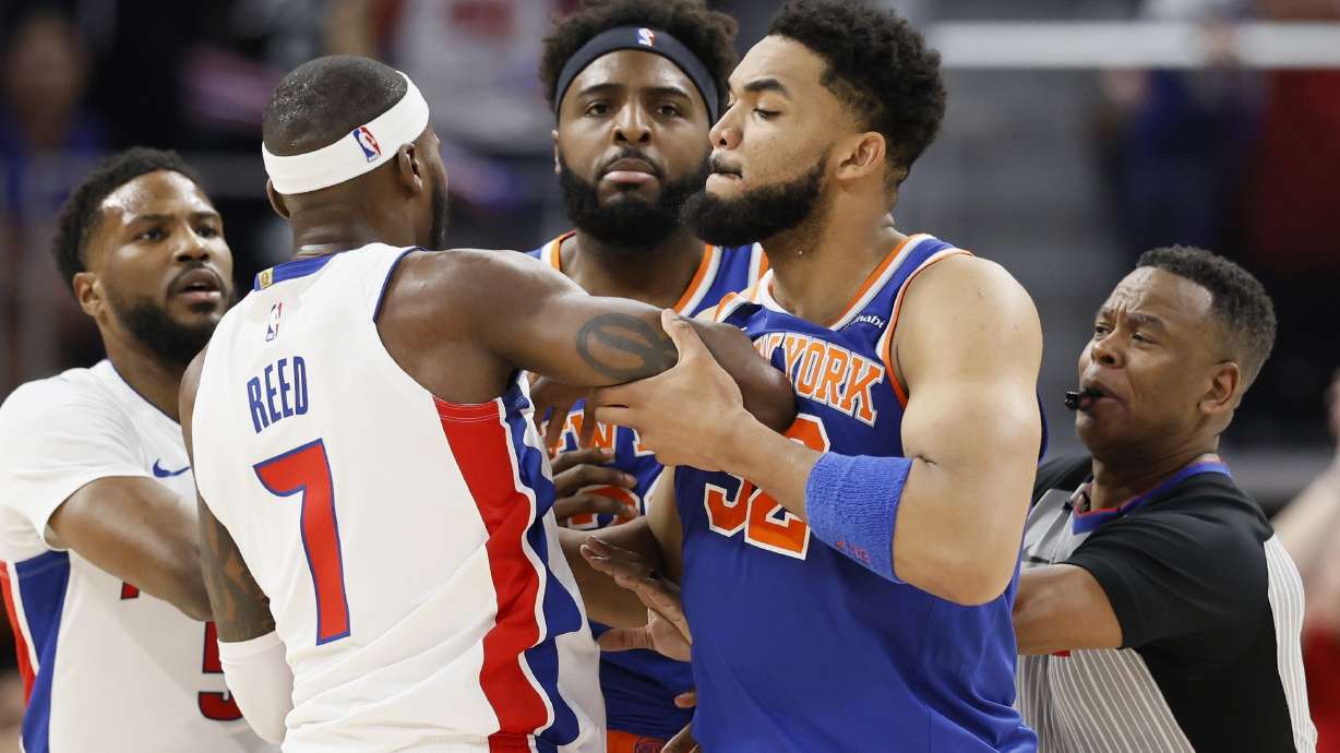 New York Knicks center Karl-Anthony Towns (32) pushes Detroit Pistons forward Paul Reed (7) away from Pistons center Mitchell Robinson, center, during a scuffle during the first half of Game 3 of an NBA basketball first-round playoff series Thursday, April 24, 2025, in Detroit.