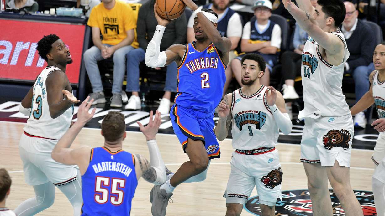 Oklahoma City Thunder guard Shai Gilgeous-Alexander (2) looks to pass between Memphis Grizzlies forward Jaren Jackson Jr. (13), guard Scotty Pippen Jr. (1), and center Zach Edey (14) in the second half of Game 3 of an NBA first-round playoff series Thursday, April 24, 2025, in Memphis, Tenn.