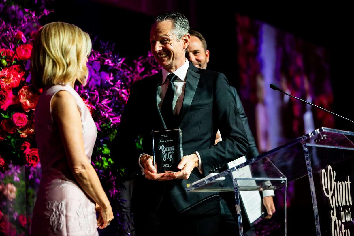 President and CEO of the Salt Lake Chamber Derek Miller, right, awards President and COO of the George S. and Dolores Doré Eccles Foundation Lisa Eccles, left, with the 46th Giant in our City award at the Salt Lake Chamber’s 2025 Giant in our City Celebration at The Grand America Hotel in Salt Lake City on Thursday.