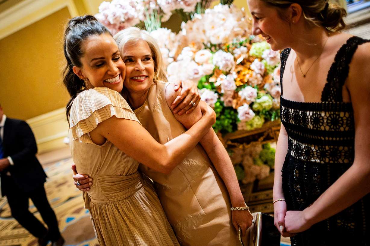 President and COO of the George S. and Dolores Doré Eccles Foundation Lisa Eccles, center, is hugged by friend Rachel Alder, of the 2034 Olympic committee, left, while Alder’s daughter Mae Alder, right, laughs before Eccles is honored with the 46th Giant in our City award at the Salt Lake Chamber’s 2025 Giant in our City Celebration at The Grand America Hotel in Salt Lake City on Thursday.