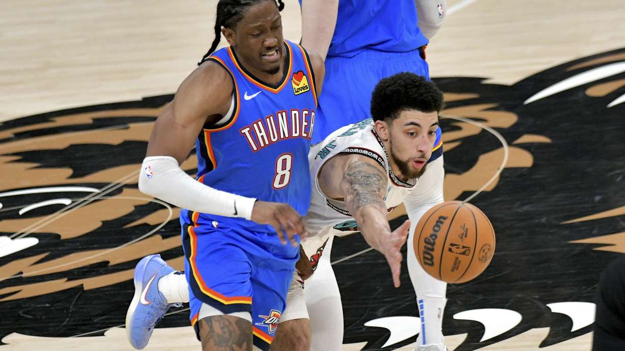 Memphis Grizzlies guard Scotty Pippen Jr., right, tries to get a loose ball ahead of Oklahoma City Thunder forward Jalen Williams (8) in the second half of Game 3 of an NBA first-round playoff series Thursday, April 24, 2025, in Memphis, Tenn.